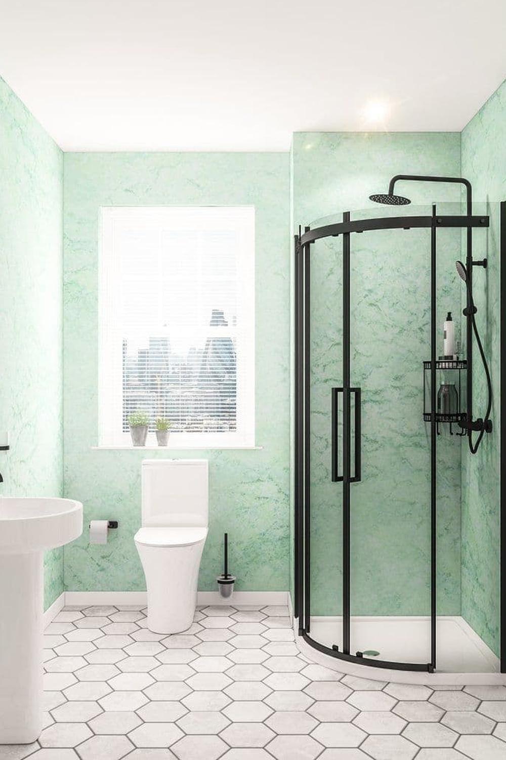 Mint green bathroom featuring a curved glass shower and white accents