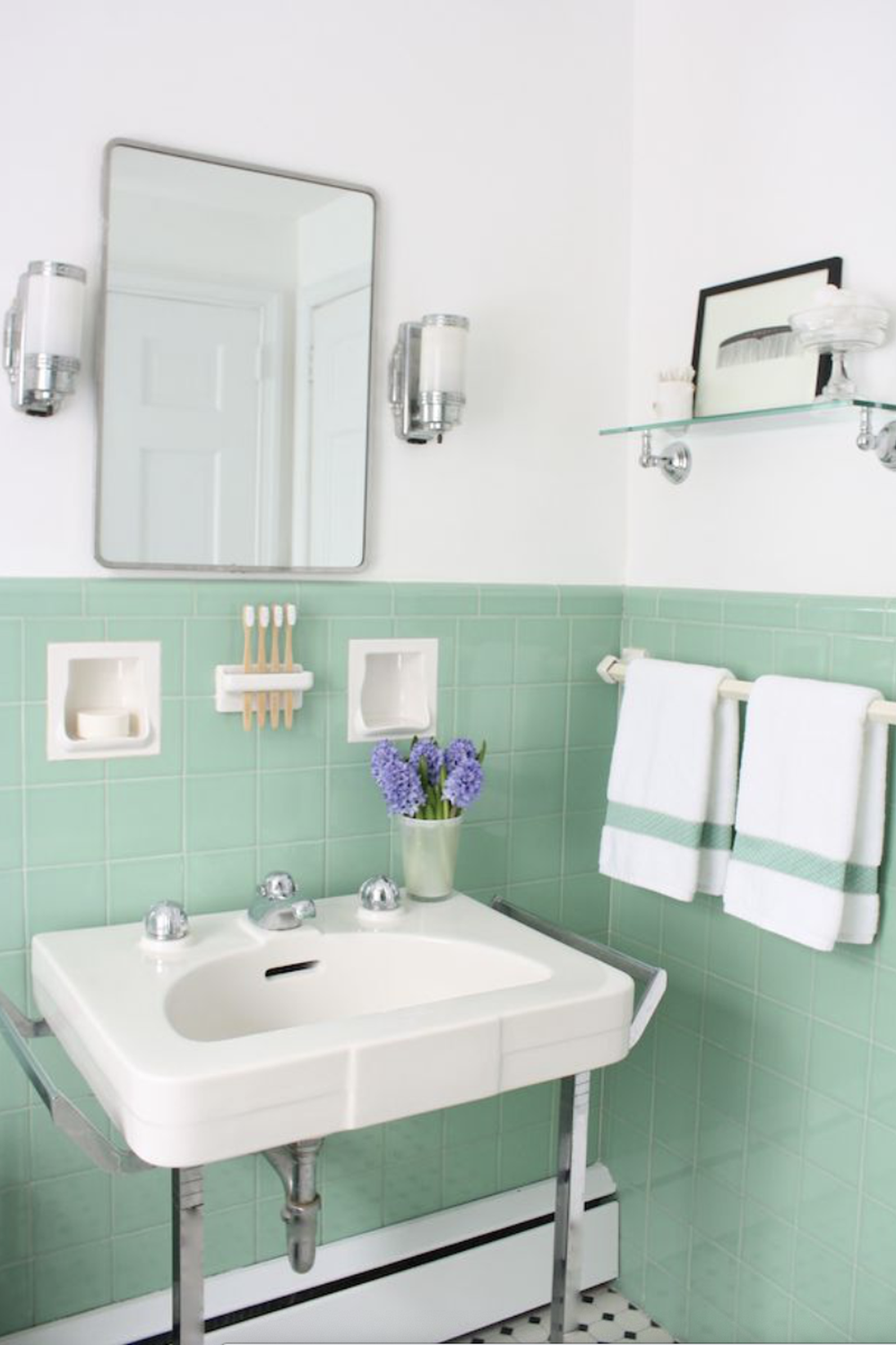Cozy bathroom featuring textured mint green tiles with vintage touches