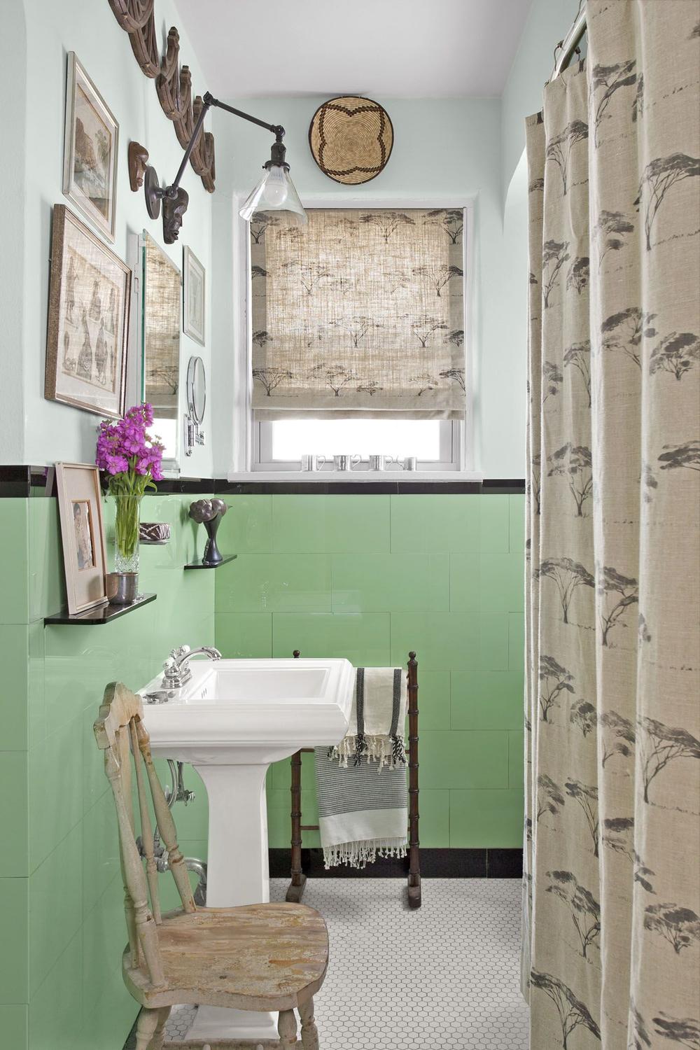 Charming bathroom with mint green tiles and natural accents