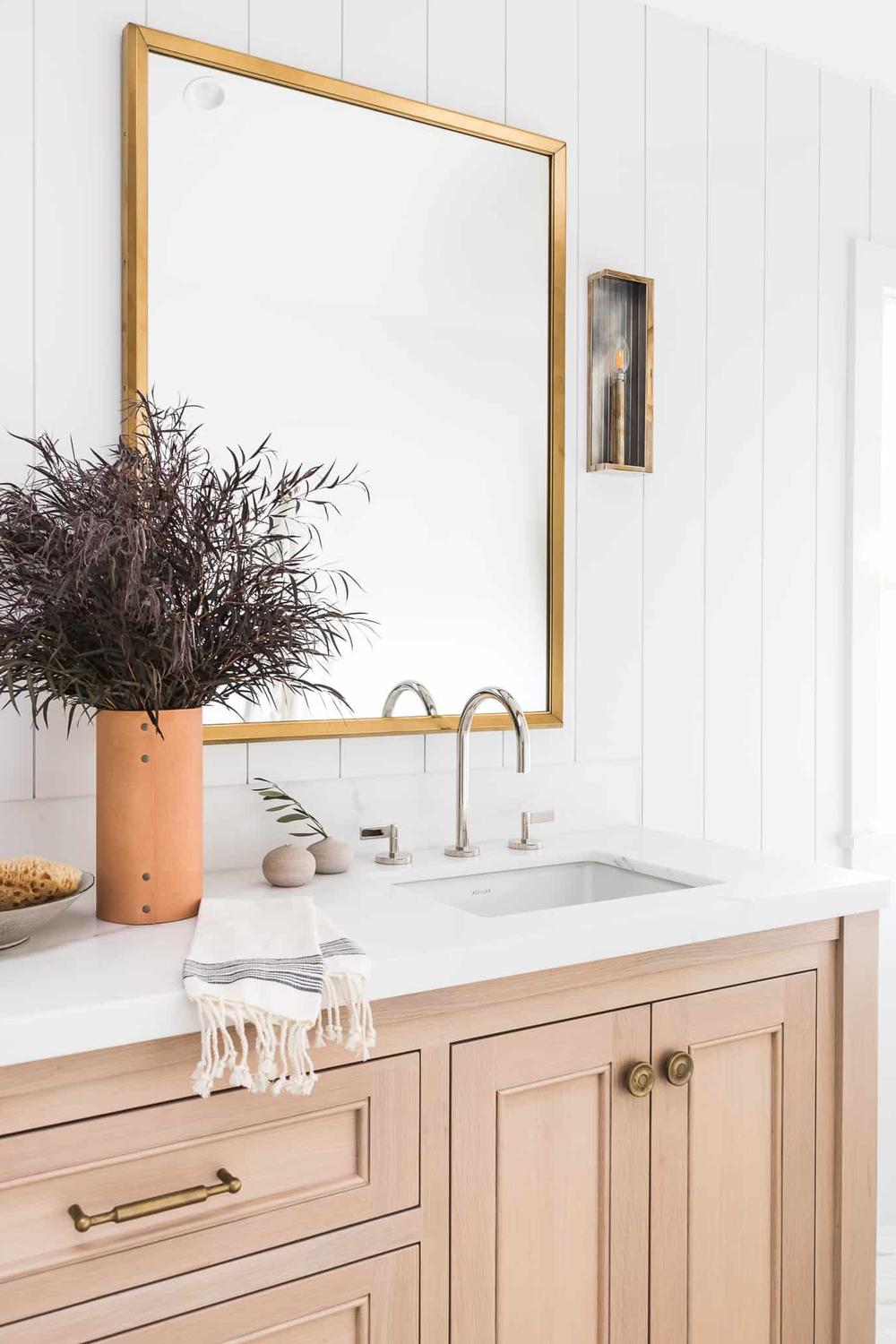 Baño minimalista con metales mixtos y un diseño contemporáneo.