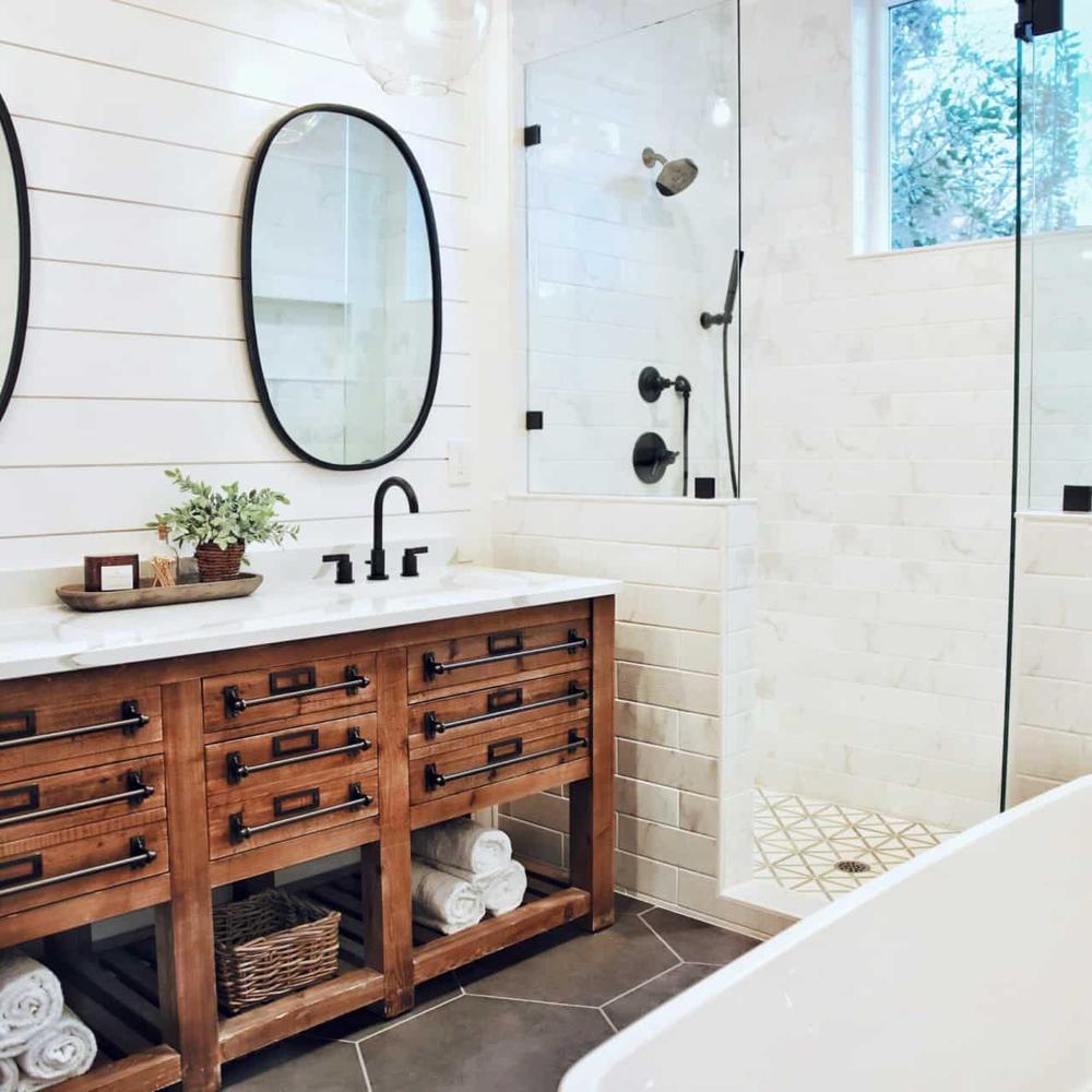 Modern aesthetic farmhouse bathroom with dark and light contrasts.