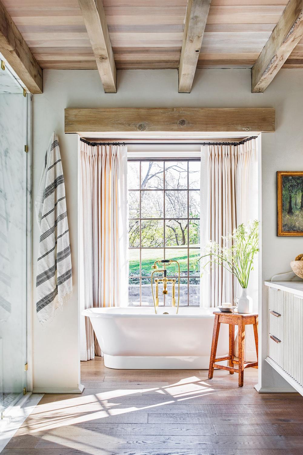 Balanced modern farmhouse bathroom with herringbone flooring and soft colors.
