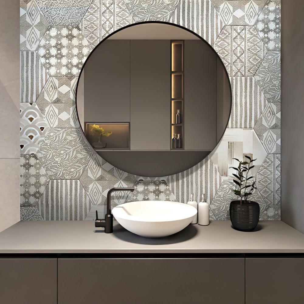 A modern bohemian bathroom with geometric patterned tiles and a round mirror.