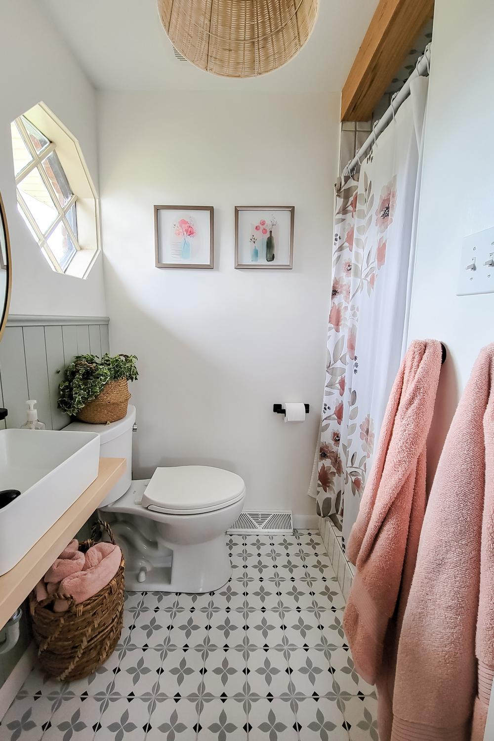An elegant modern bohemian bathroom featuring monochromatic patterned tiles.