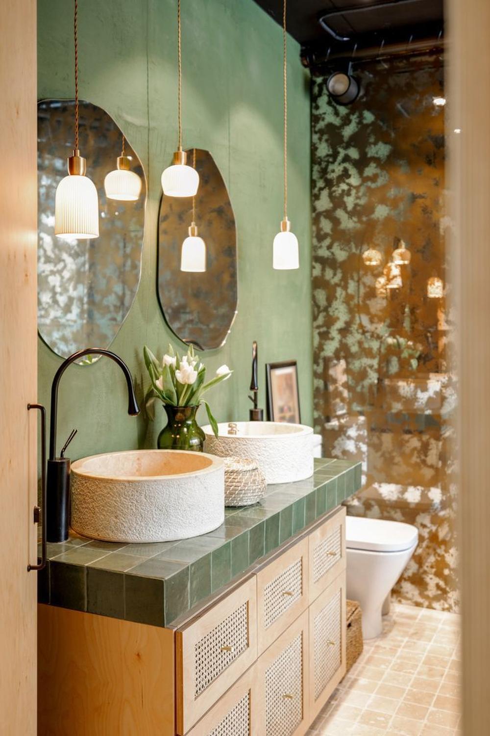 A rich green modern bohemian bathroom characterized by eclectic design and inviting decor.