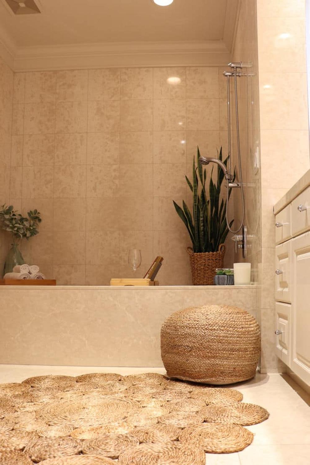 A calming modern bohemian bathroom featuring neutral colors and natural textures.