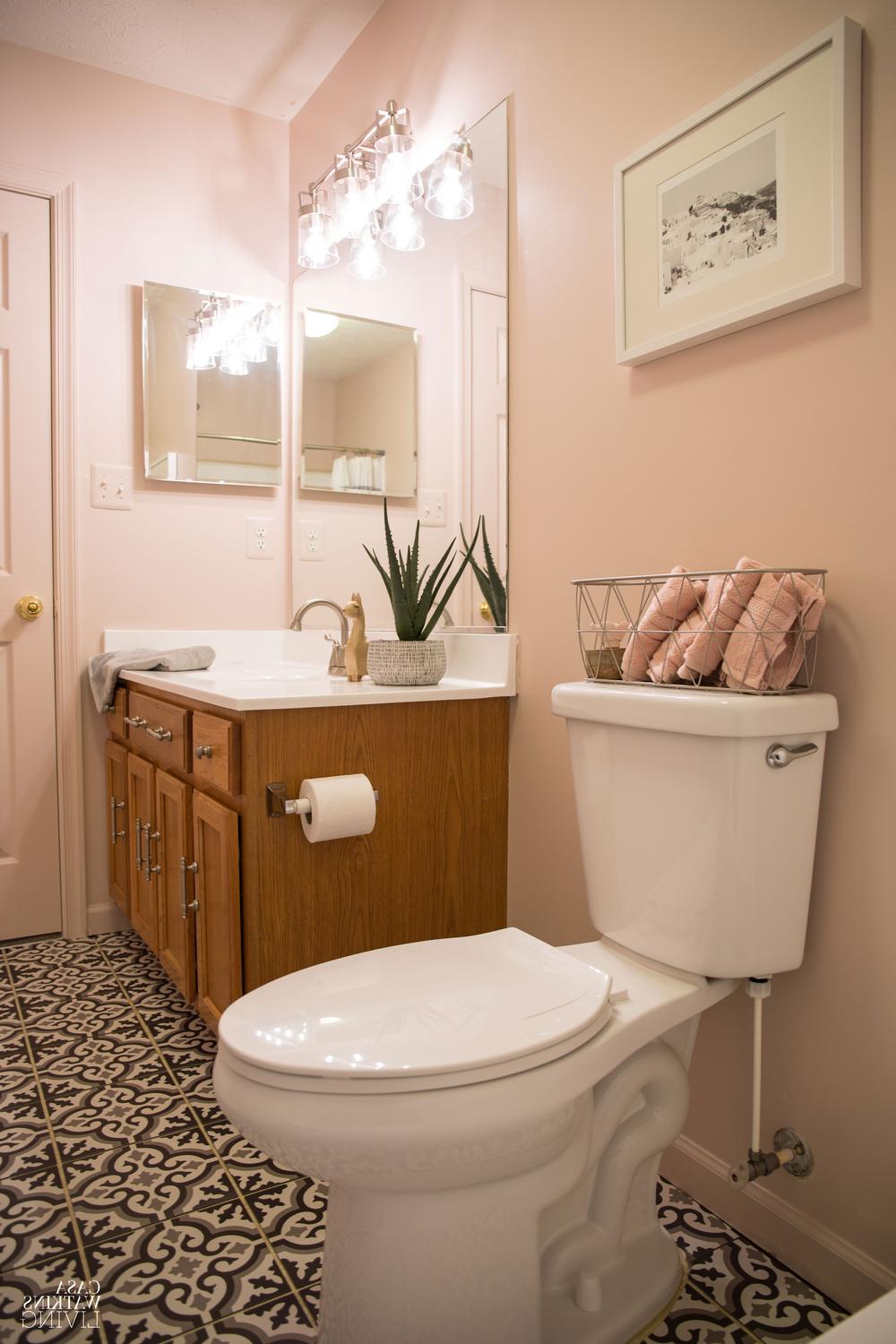 An elegant pastel modern bohemian bathroom highlighted by bold patterns and warm accents.
