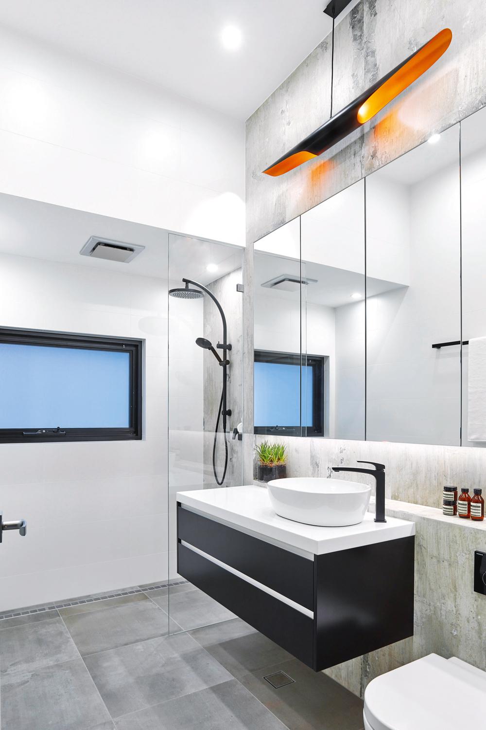 Modern monochromatic bathroom featuring sleek lines and designs.