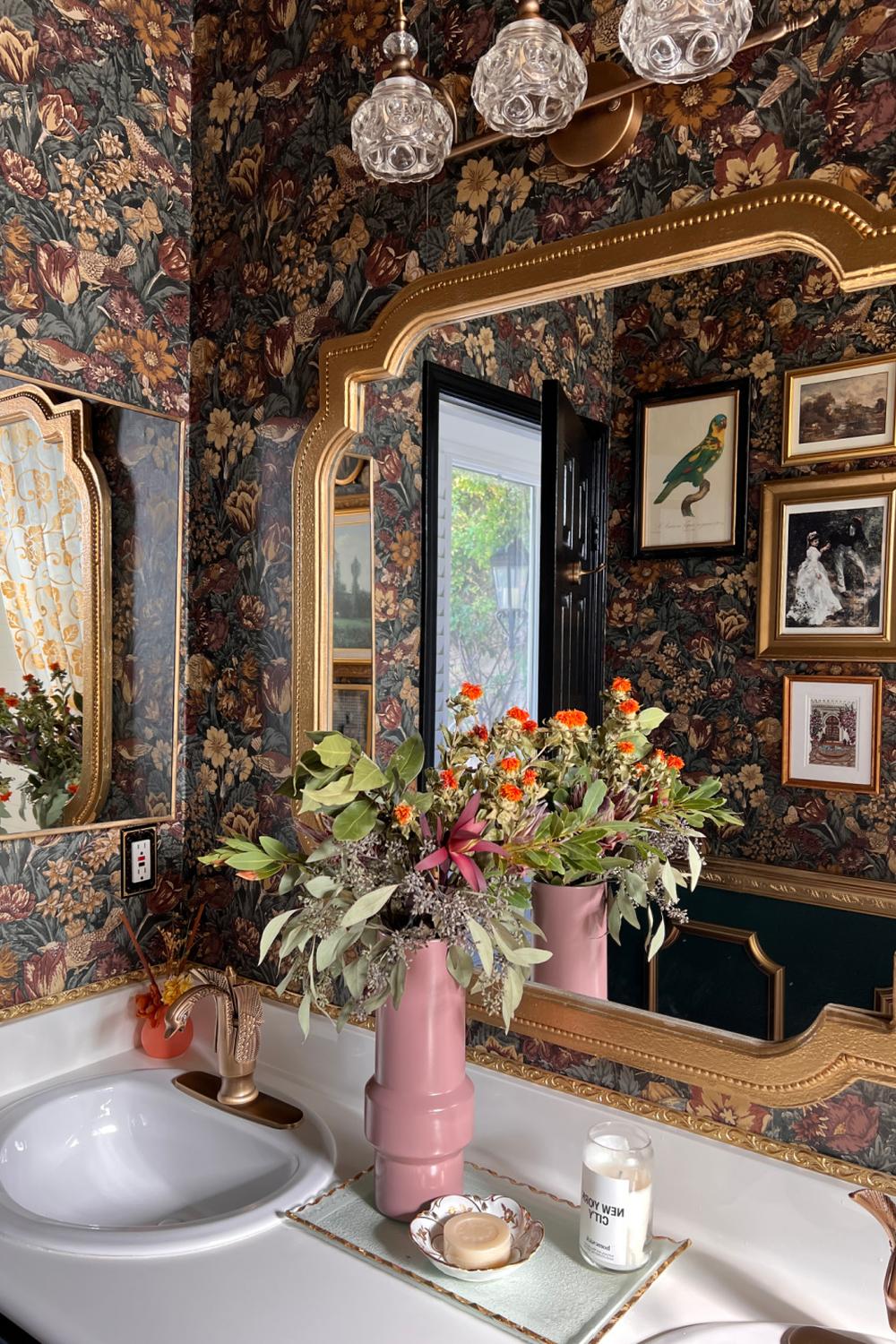 Beautifully designed bathroom with dark floral wallpaper and luxurious accents.
