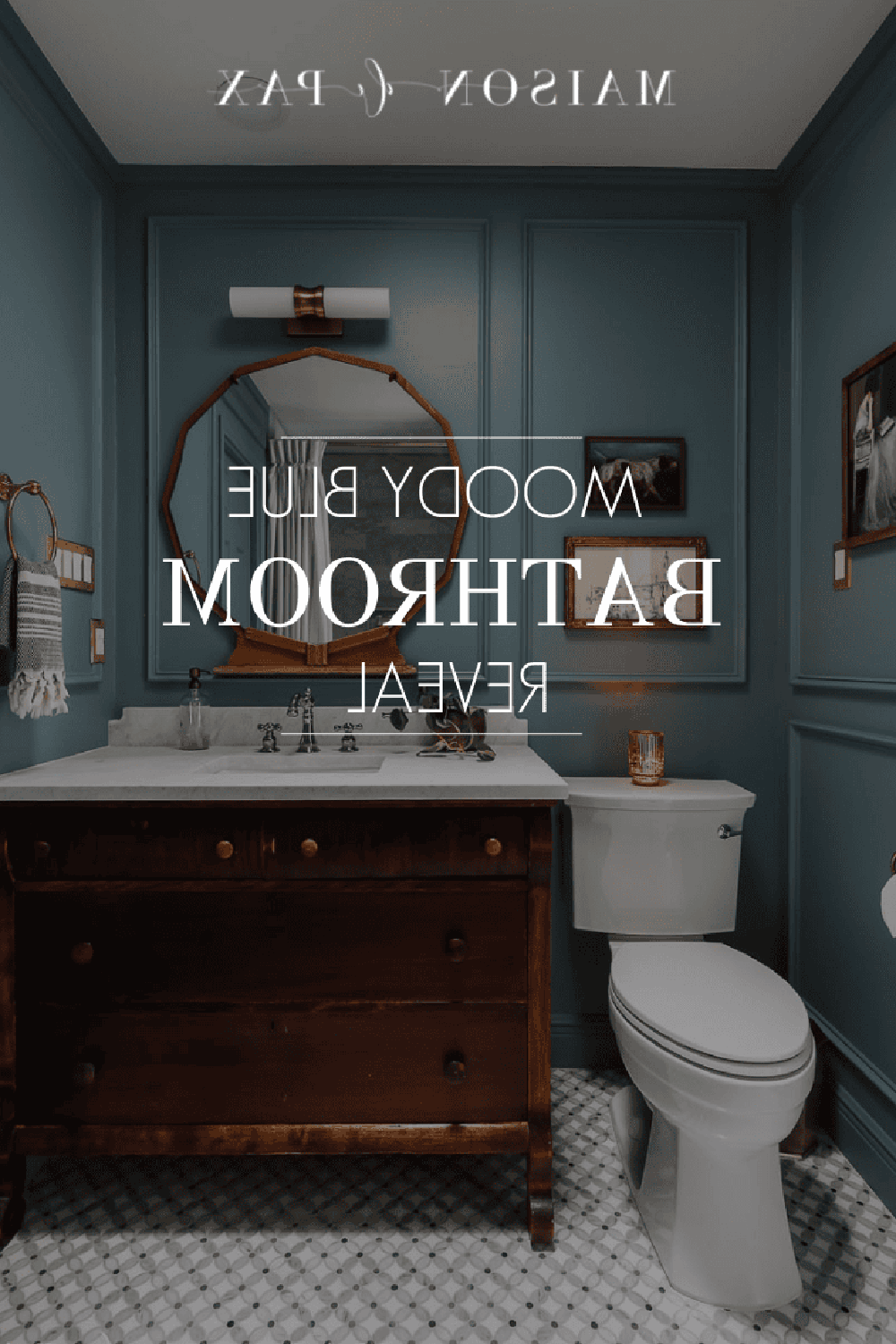 A vintage-style moody blue bathroom with a white marble countertop and elegant fixtures.