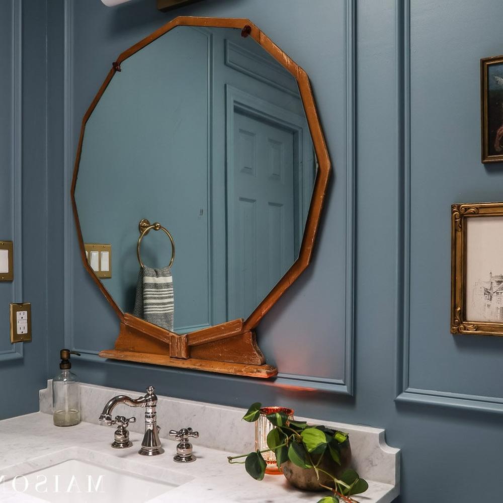 A calm moody blue bathroom with intricate details and stylish accessories.