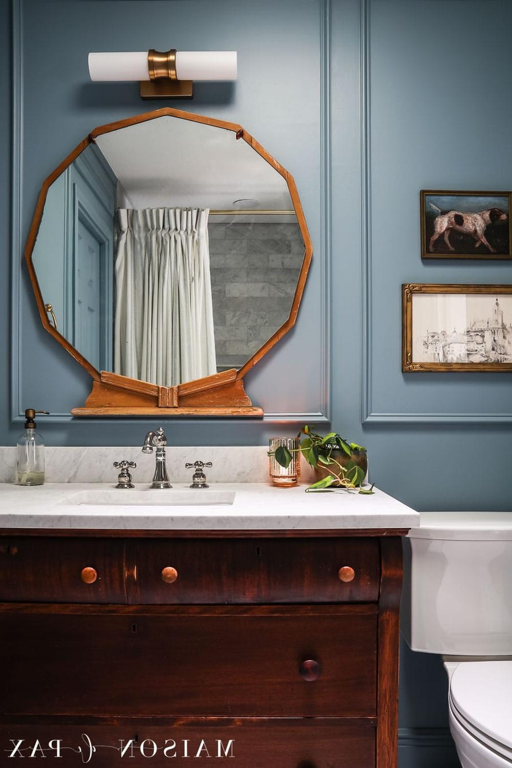 A moody blue bathroom showcasing a cozy atmosphere with stylish decorations.