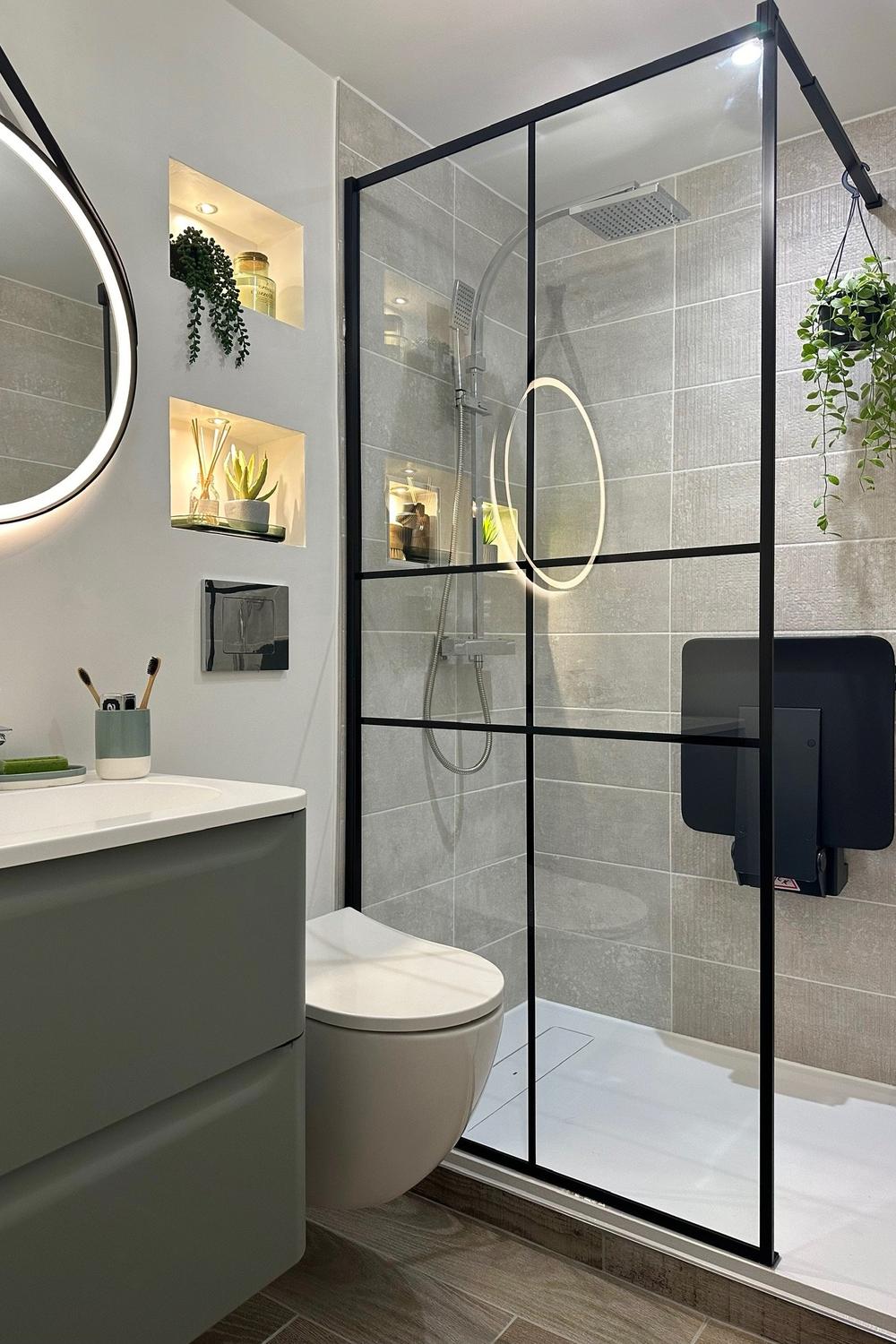 Contemporary narrow bathroom with sleek black-framed glass shower panels and modern fixtures