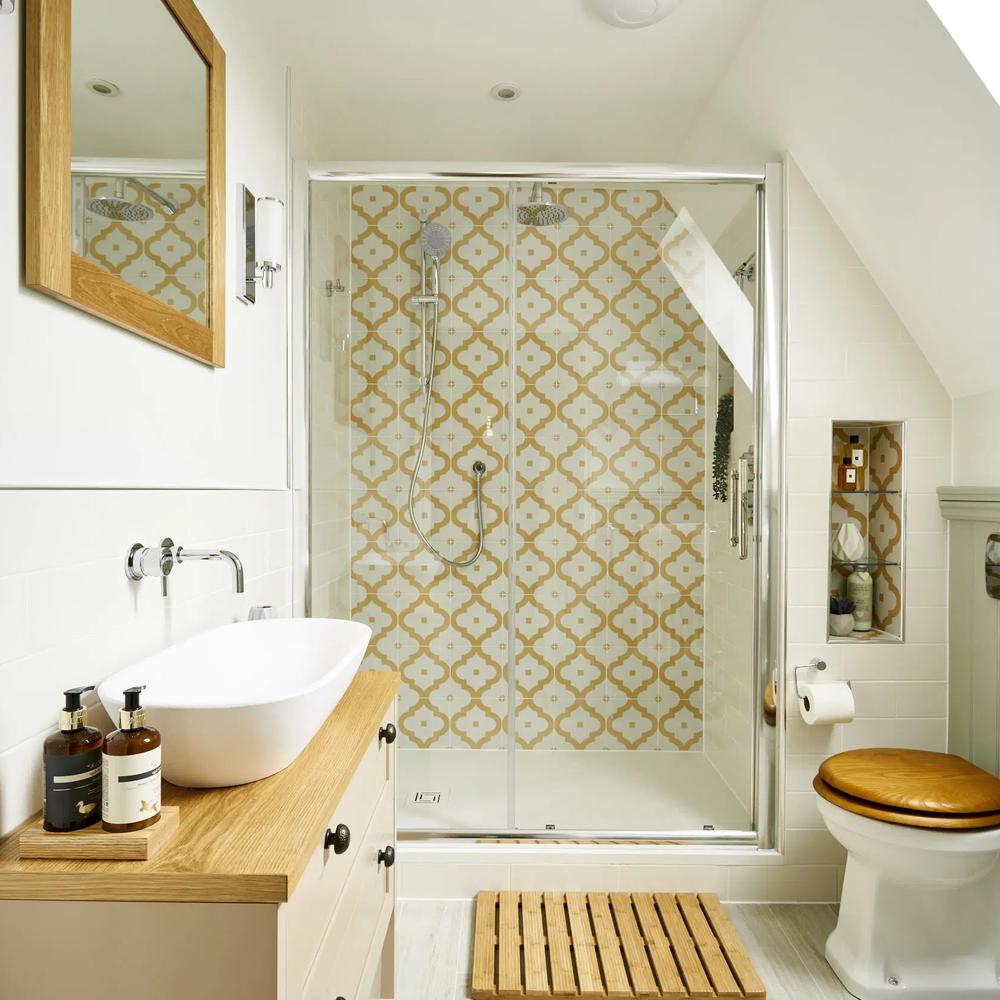 Compact narrow bathroom with geometric shower tiles and modern fixtures