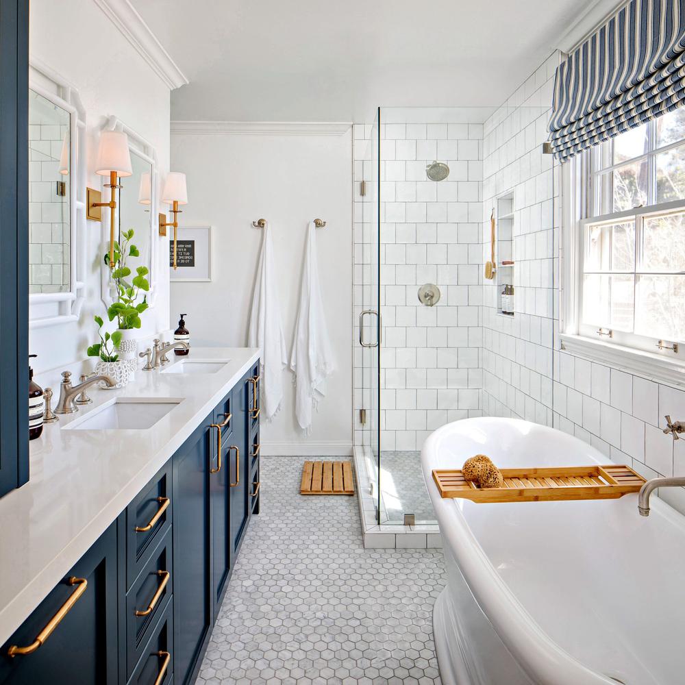 Stylish narrow bathroom featuring dual vanities and a freestanding bathtub