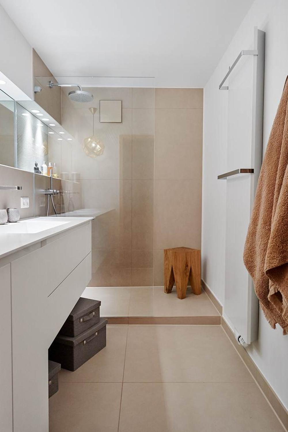 Warm-toned narrow bathroom with soft lighting and cozy decor