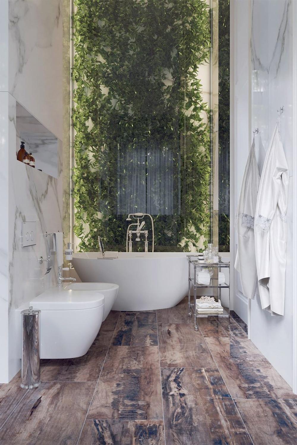 A nature-inspired bathroom featuring a lush vertical garden and a sleek freestanding bathtub