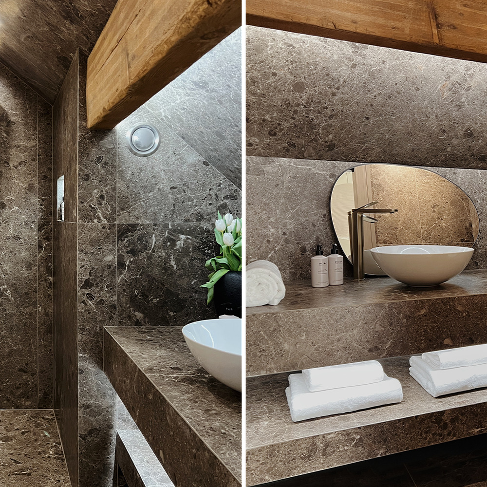 A beautifully designed bathroom with stone finishes and warm wood accents
