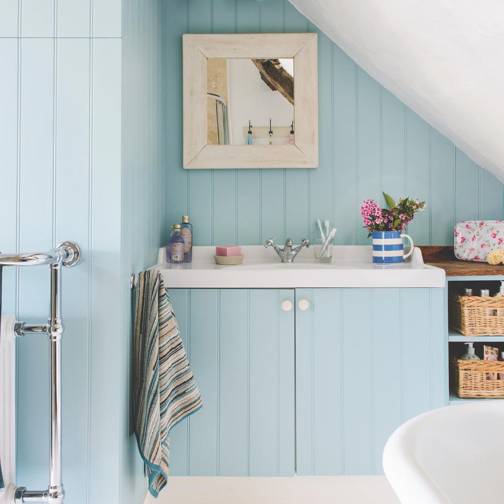 Baño náutico con paneles de madera clara