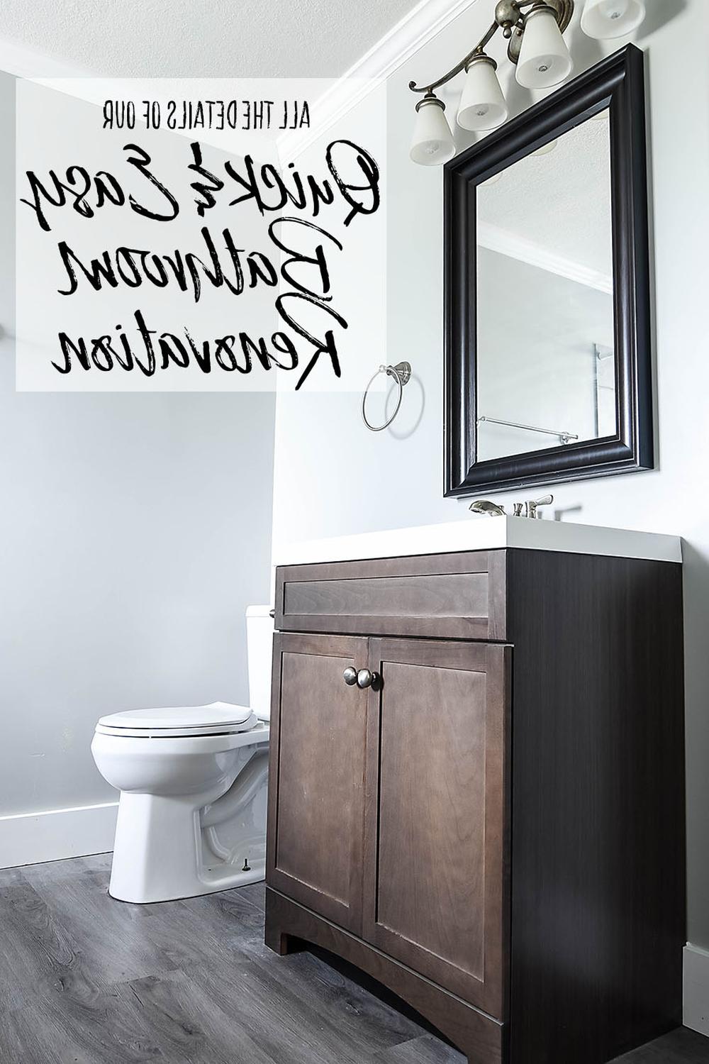 Modern bathroom design with dark wood vanity and light grey walls.