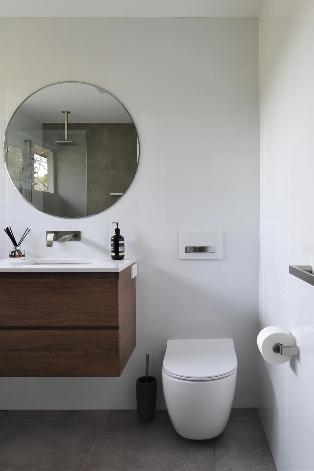 Minimalist bathroom featuring earthy tones and clean lines.