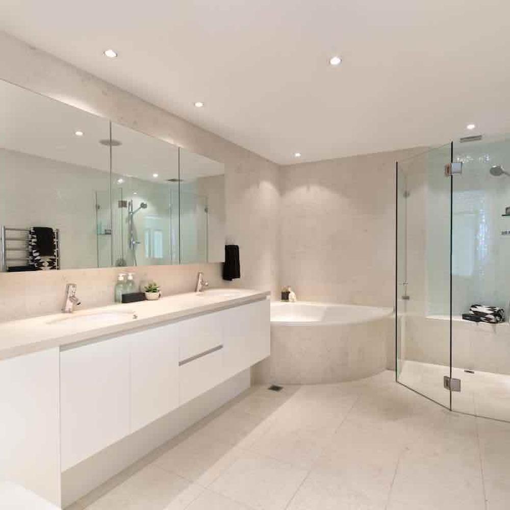 Clean no-tile bathroom featuring beige tones and minimalist accessories.