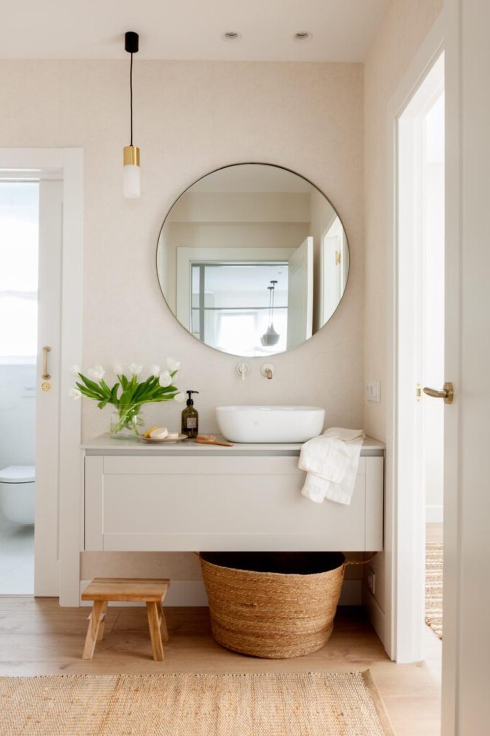 Stylish bathroom with a light grey vanity and fresh flowers.