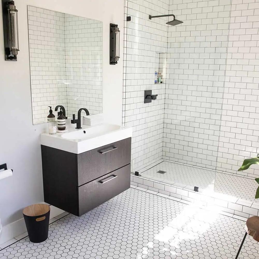 Contemporary bathroom featuring a frameless glass enclosure and minimalist features.