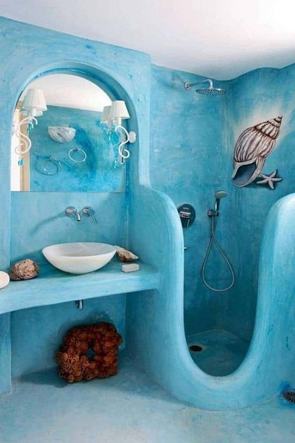 A vibrant ocean-themed bathroom featuring shades of blue and modern decor.