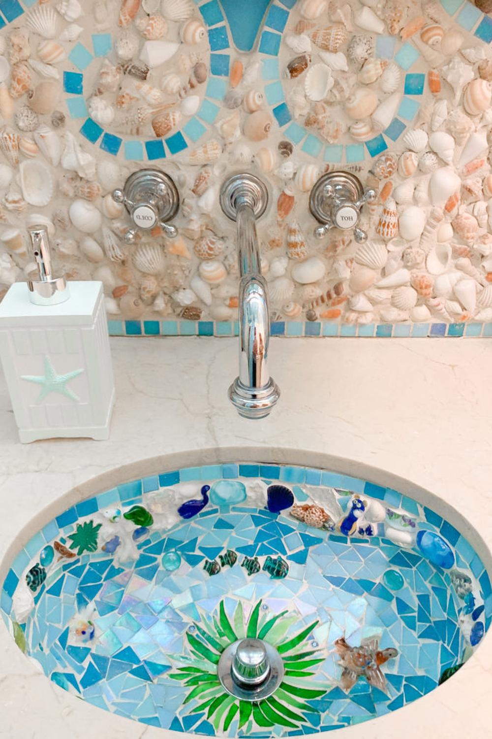 A stylish sink area with a mosaic bowl and lovely decorative elements.