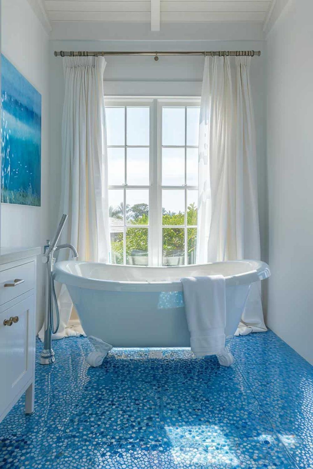 A serene bathroom featuring turquoise decor and elegant flooring.
