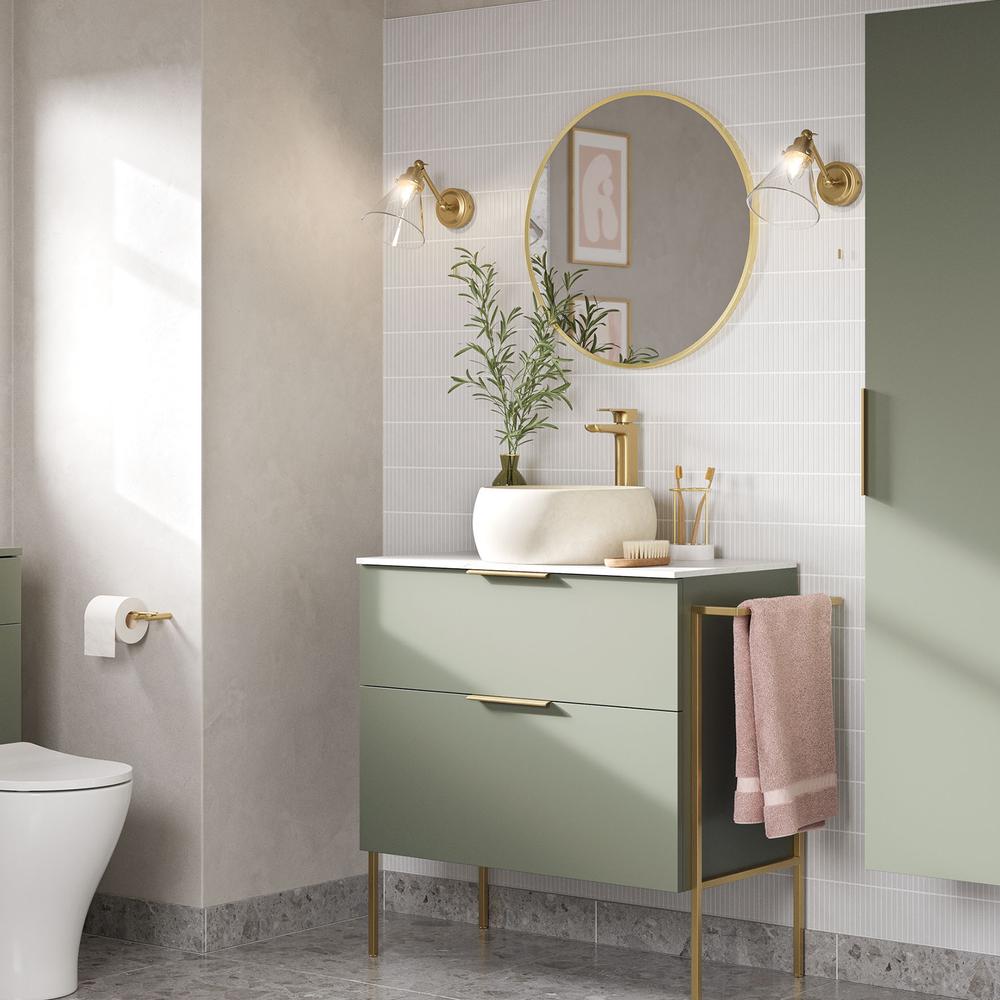 A chic modern bathroom with olive green vanity and golden fixtures.