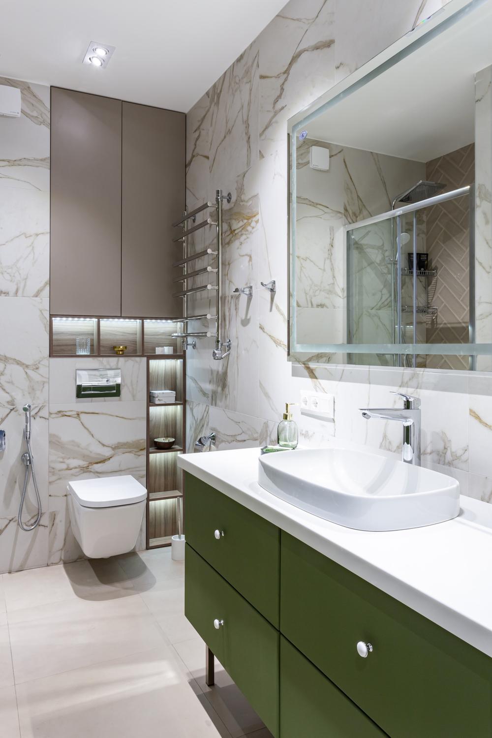 A neutral bathroom landscape accented with bold olive green tones.