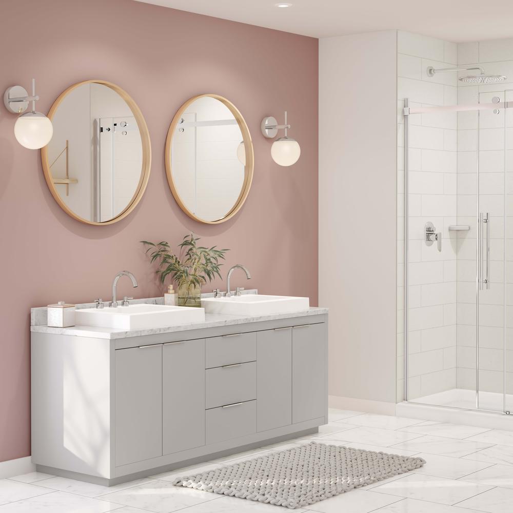 A modern bathroom showcasing a grey cabinetry, dual sinks, and wooden accents.