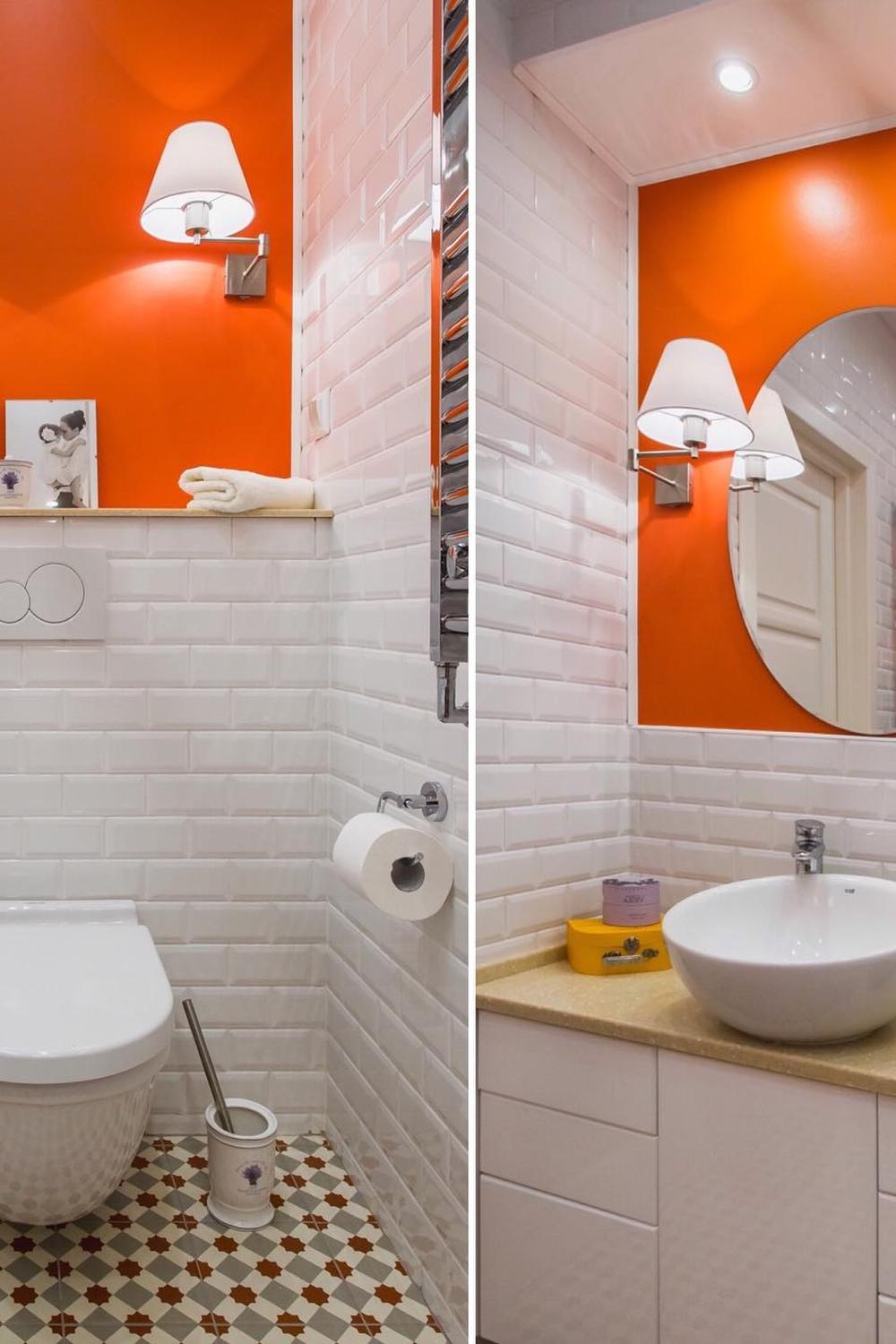 A stylish and modern bathroom featuring a vibrant orange accent wall and sleek fixtures.