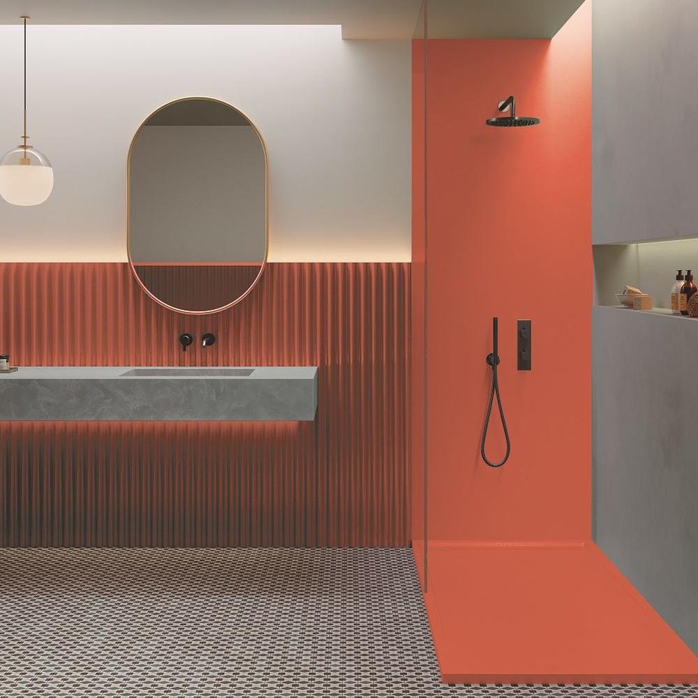 A modern bathroom with textured orange panels and clean lines.
