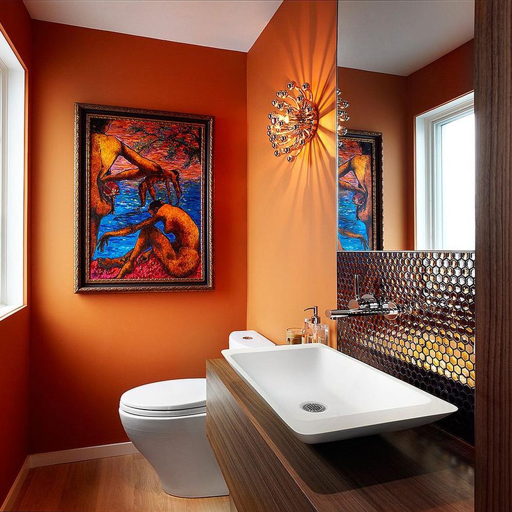An inviting orange bathroom featuring eclectic artwork and modern design elements.