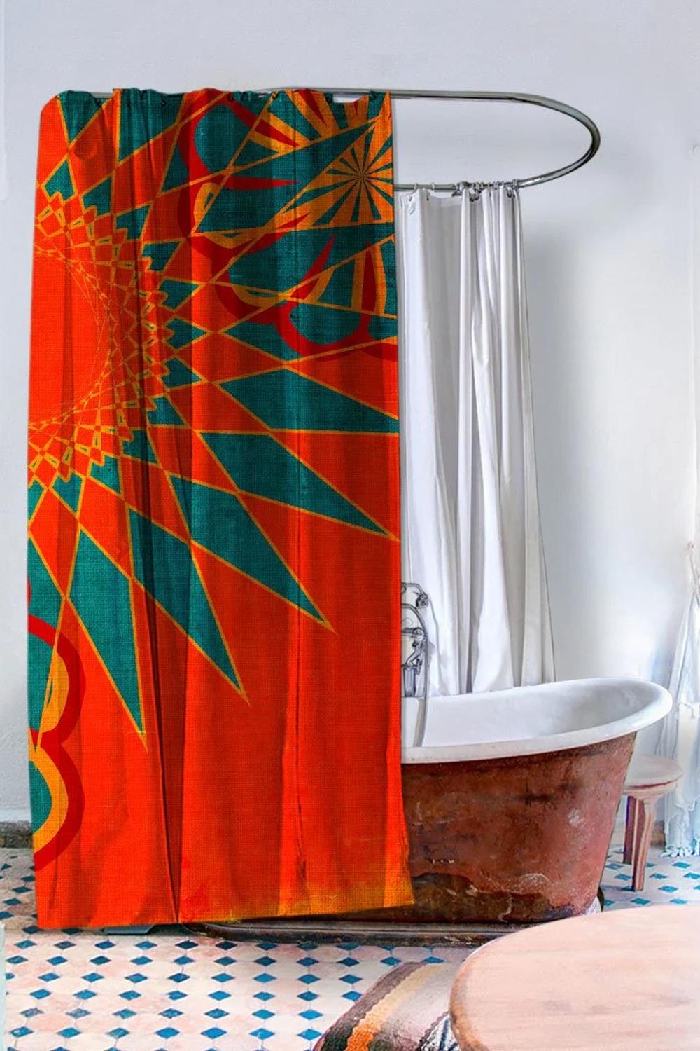 A boho-style bathroom featuring an orange shower curtain, rustic bathtub, and colorful floor tiles.