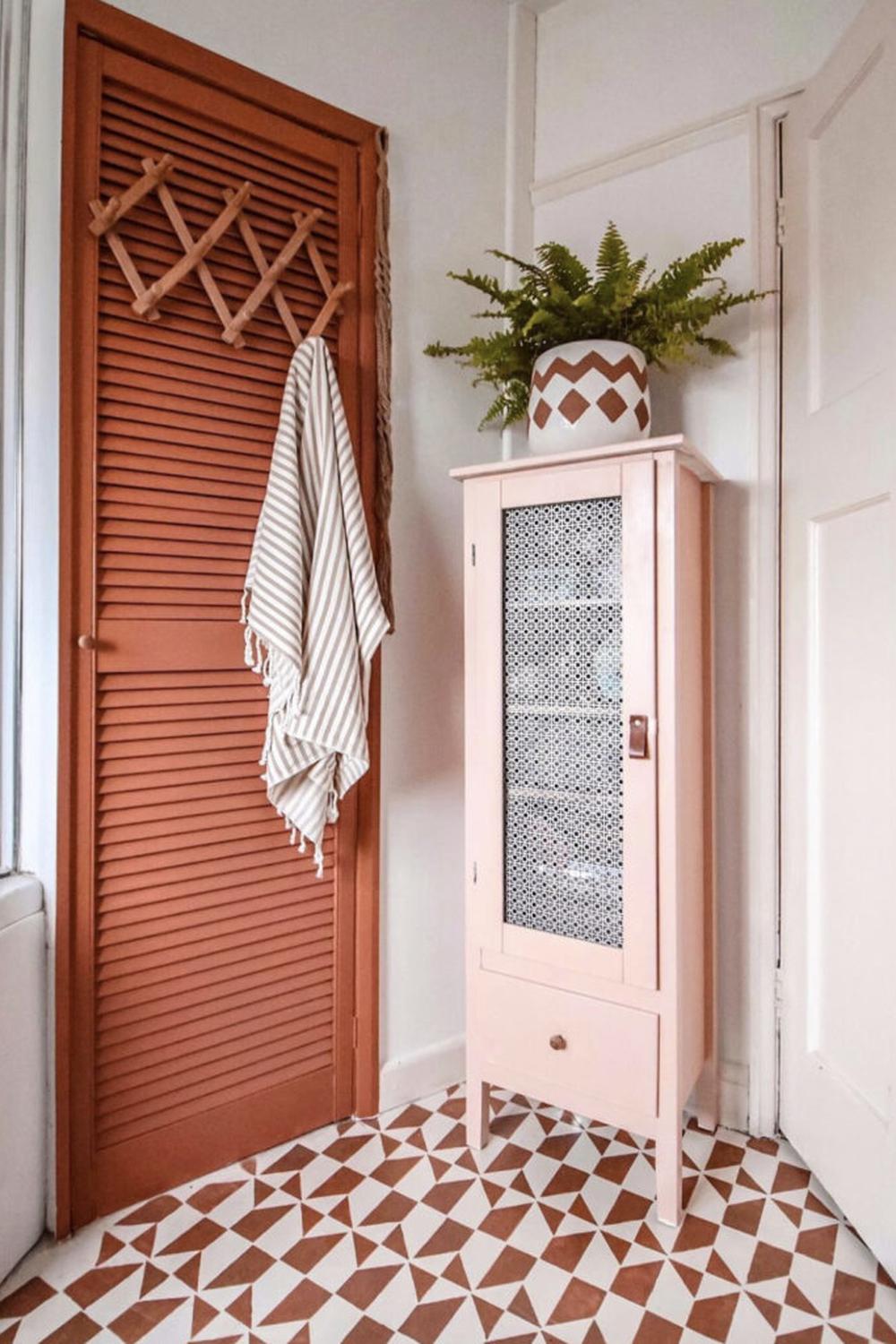 A beautifully styled corner featuring warm tones and a stylish glass cabinet.