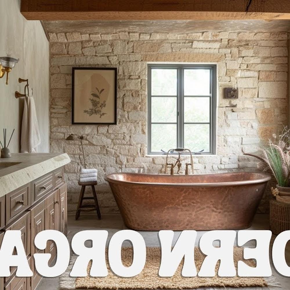 Baño con paredes de piedra y bañera de cobre