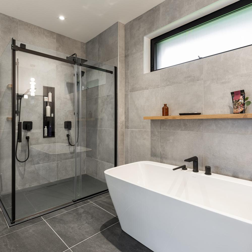 Baño moderno con duchas separadas y bañera