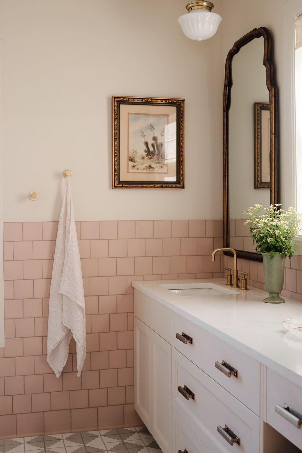 Stylishly designed bathroom with peach tiles and white accents