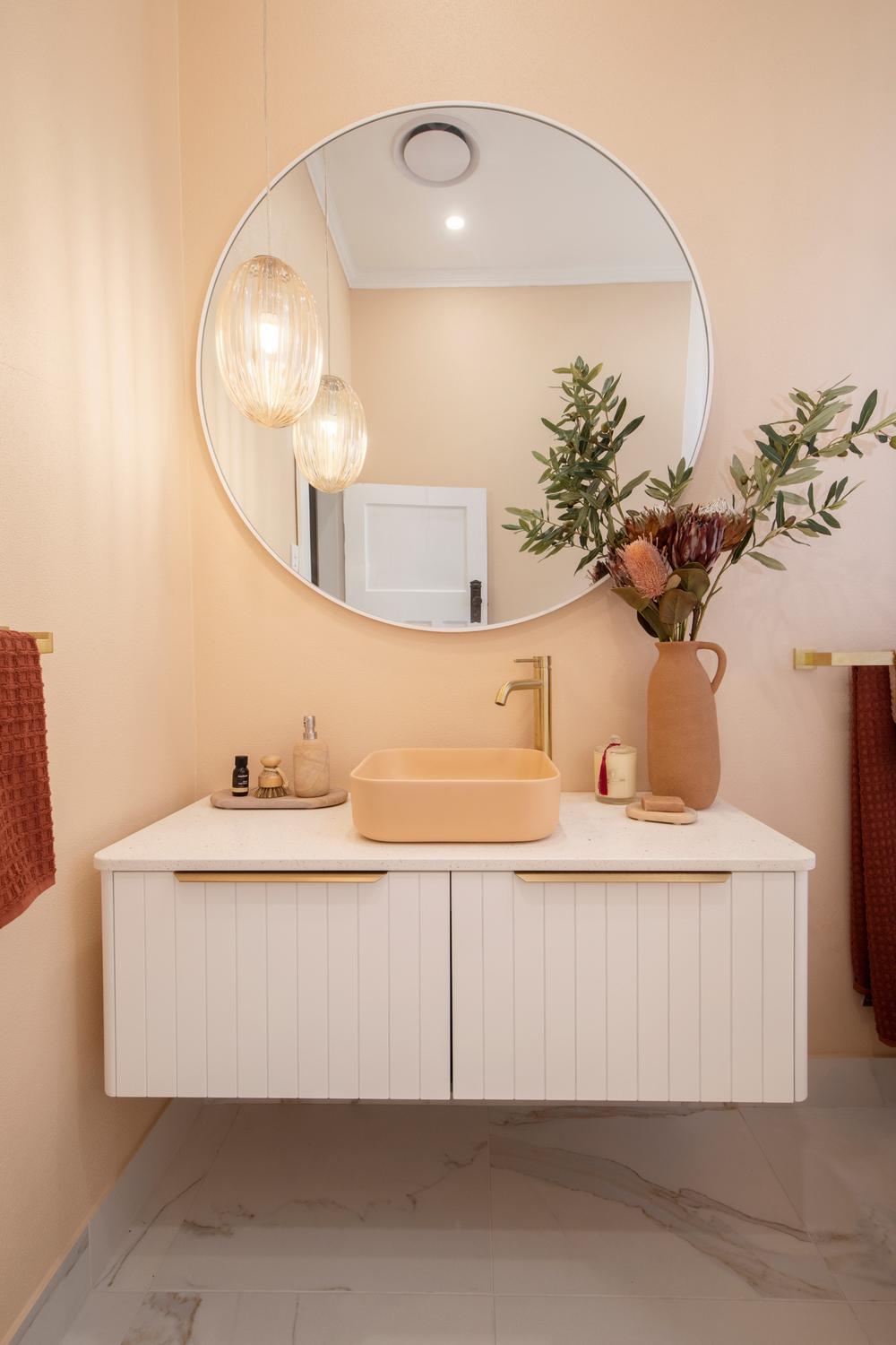 Beautiful bathroom featuring a peach tile aesthetic and modern accessories