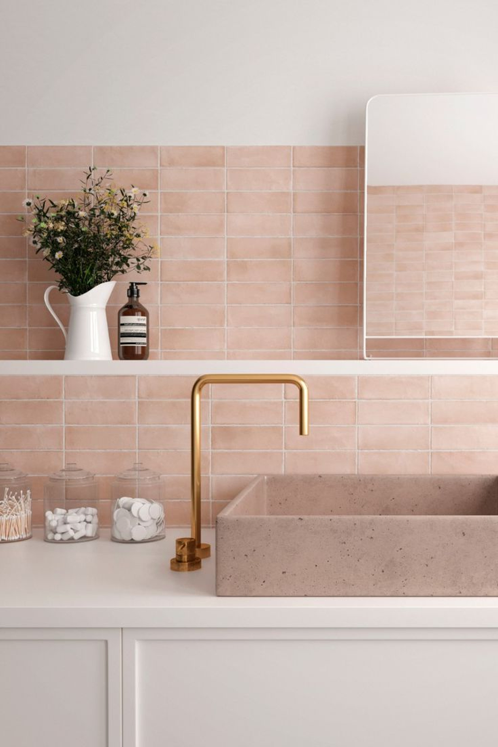 Bathroom sink area with a peach tile backdrop and modern decor