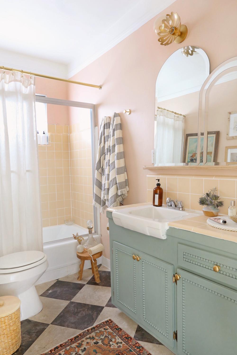 Charming bathroom featuring a vintage feel with peach and yellow tiles