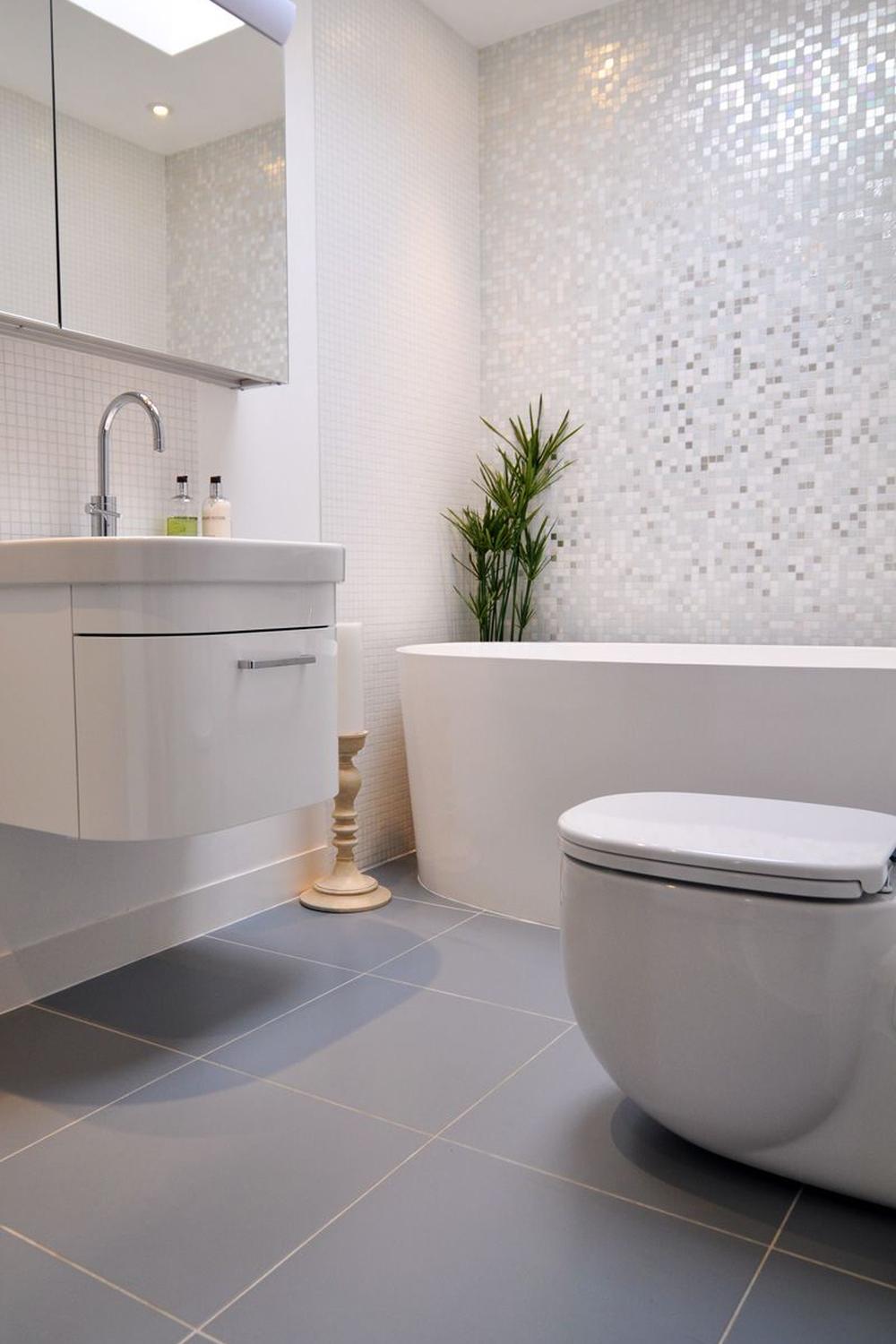 Bathroom featuring modern lighting fixtures in a serene pearl gray atmosphere