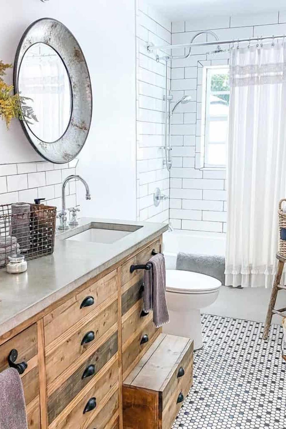 A modern rustic bathroom featuring a combination of penny tile flooring and wooden vanity accents.