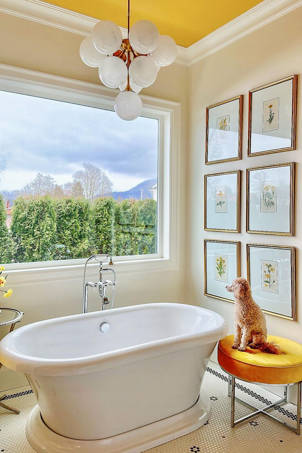 A bright bathroom featuring a freestanding tub and cheerful decor in warm colors.