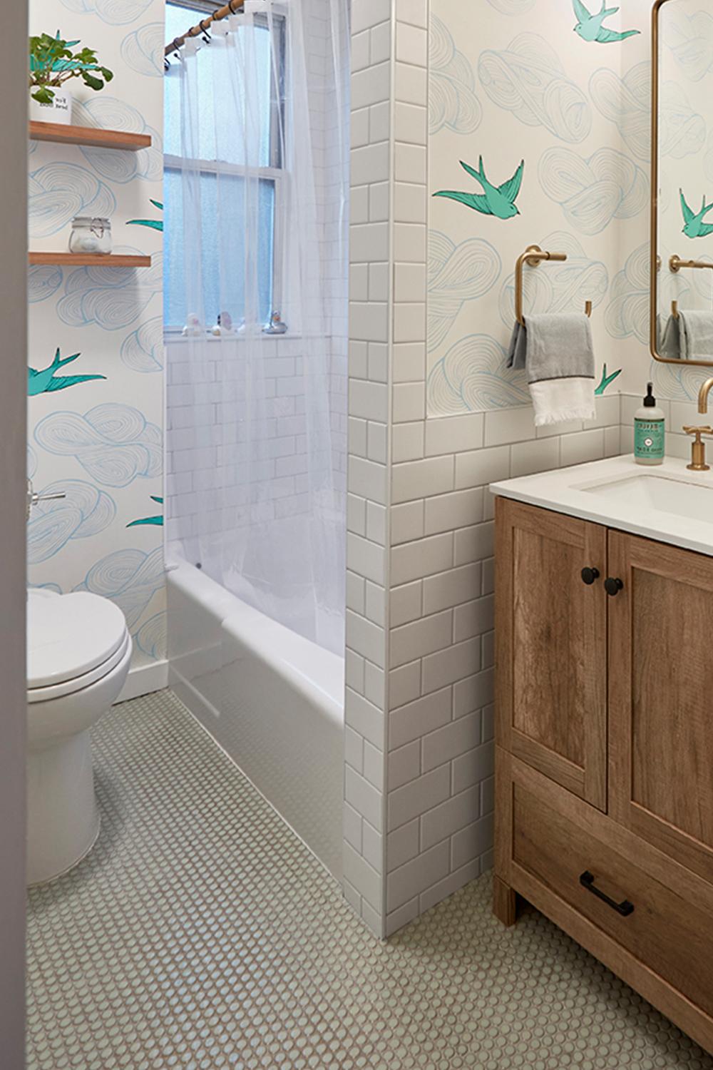 A modern bathroom featuring soft neutrals and abundant natural light.