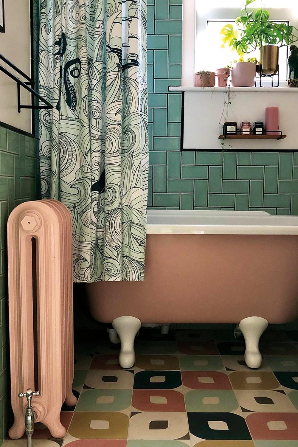 Stylish bathroom featuring pink freestanding bathtub and green subway tiles